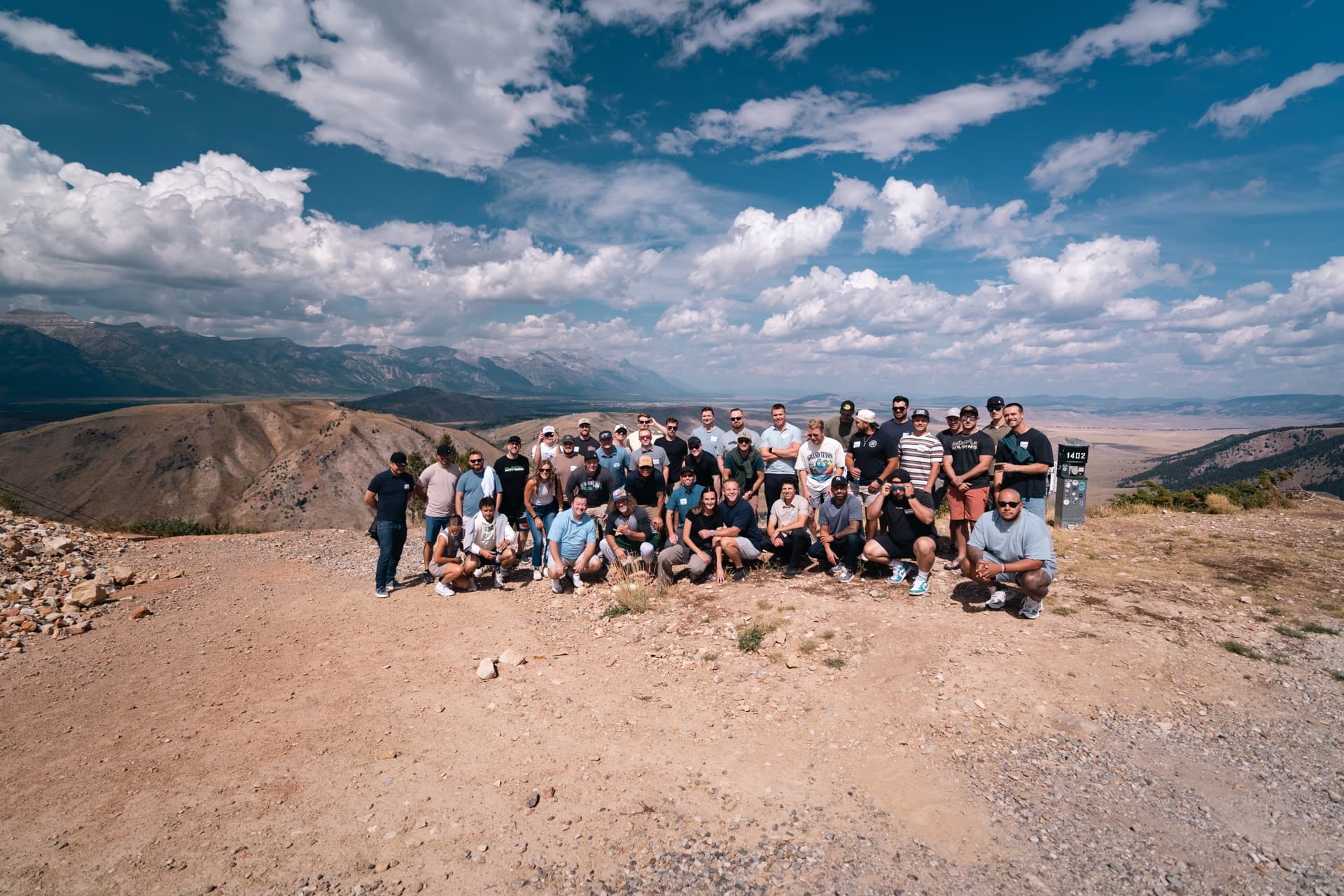 Group photo at the mountain summit with Grand Teton views